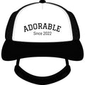 Noble&Tail black and white trucker hat with "ADORABLE Since 2022" embroidered on the front. Features mesh back and ear holes.