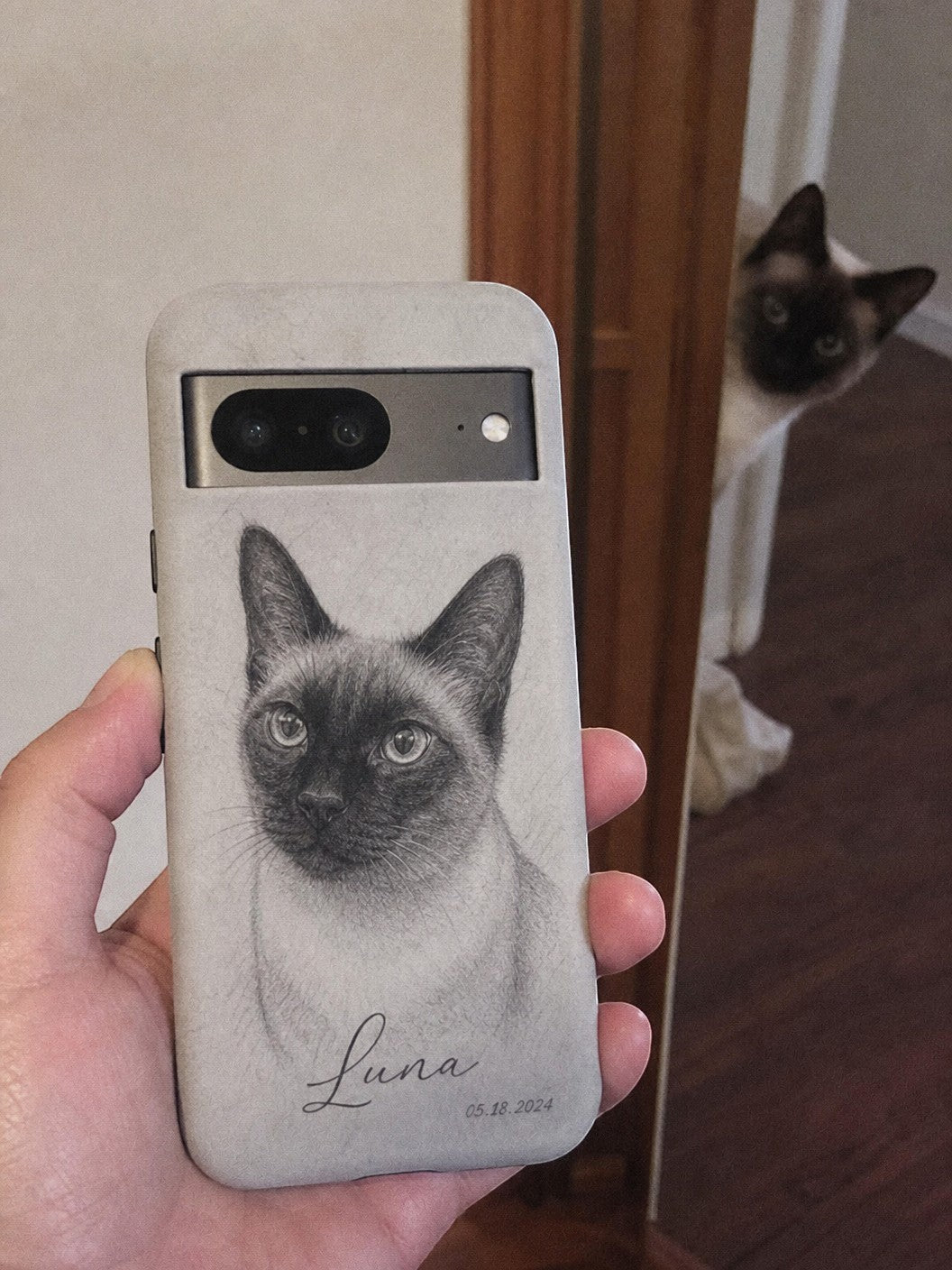 Noble&Tail custom sketch phone case featuring a Siamese cat portrait, with name Luna and date 05.18.2024.